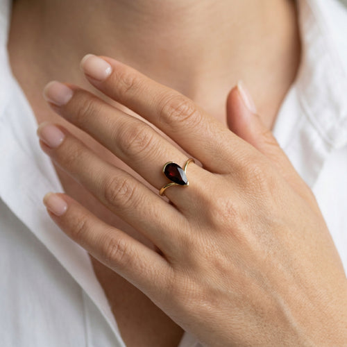 Simple pear cut garnet yellow gold ring