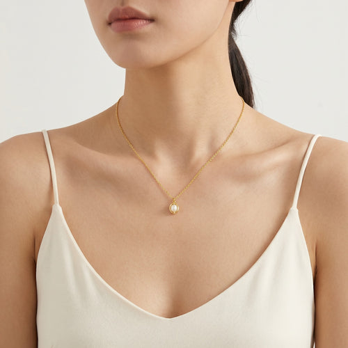 Gold caged pearl necklace