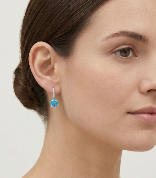 Sterling silver drop earrings with round blue topaz