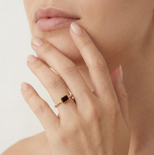 Emerald cut garnet ring in bezel setting