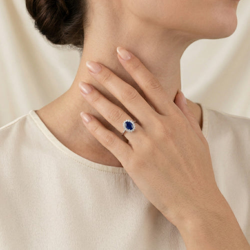 Halo oval cut sapphire on sterling silver ring
