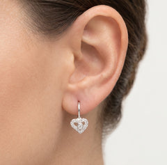 Silver earrings with heart and stone in the middle