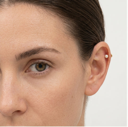 One pearl gold piercing