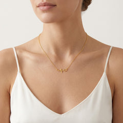 Gold necklace with heartbeat symbol