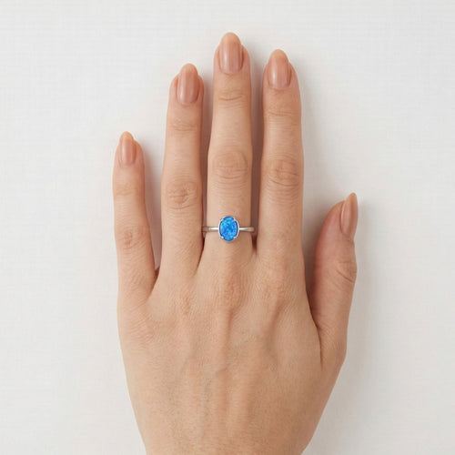 Tiny prong oval blue opal ring