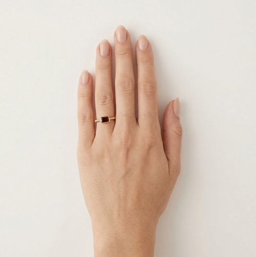 Emerald cut garnet ring in bezel setting