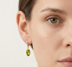 Oval cut modavite in gold earrings