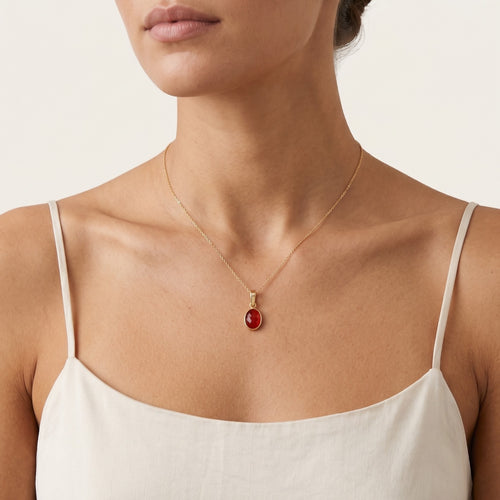 Oval cut garnet pendant in bezel setting