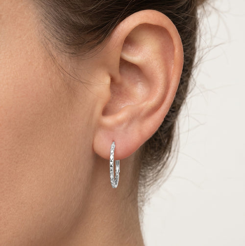 Diamond-cut white gold hoop earrings