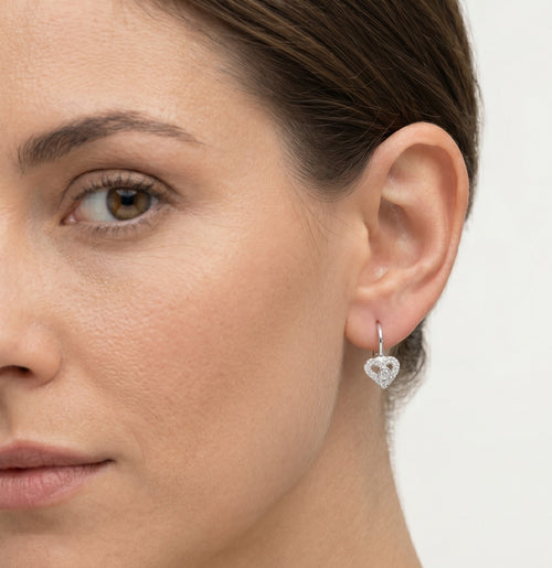 Silver earrings with heart and stone in the middle