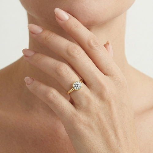 Yellow gold bezel set lustrous ring