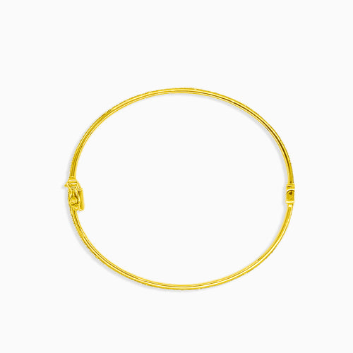 Gold bangle bracelet with white gold edges