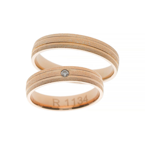 Rose gold wedding ring with flat polished lines and stone