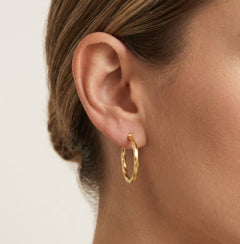 Twisted yellow gold hoop earrings