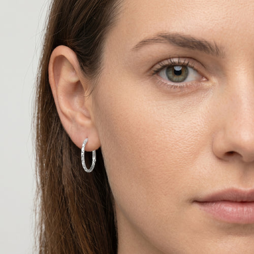 Diamond-cut white gold hoop earrings