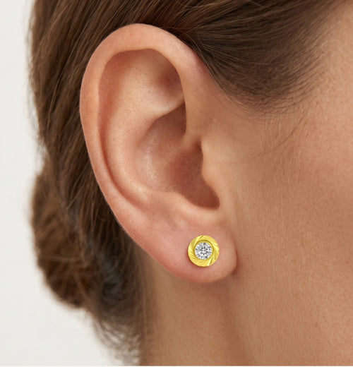 Lustrous gold with round cubic zirconia stud earrings