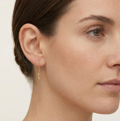 Unique gold earrings with a coin