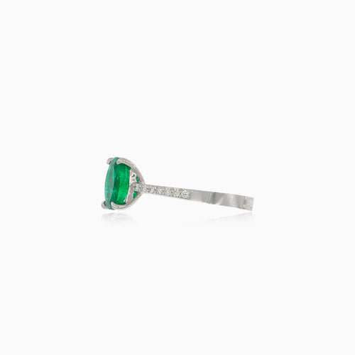 White gold ring with oval emerald and diamonds