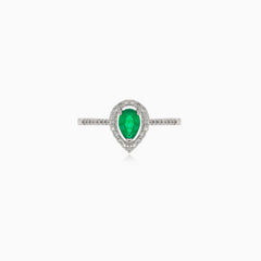 White gold ring with diamonds and pear cut emerald