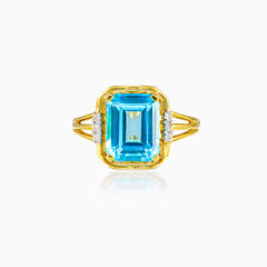 Prsten s modrým topazem a diamanty smaragdového brusu ve žlutém zlatě