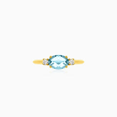 Three stone ring with topaz and cubic zirconia in yellow gold