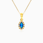 Gold oval cut blue sapphire pendant with cubic zirconia