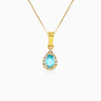 Blue topaz and cubic zirconia halo gold pendant