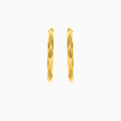 Twisted tube hoop earrings in yellow gold