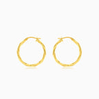 Twisted yellow gold hoop earrings