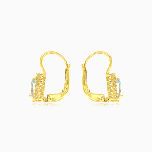 Pear cut blue topaz halo earrings in yellow gold