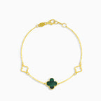 Gold bracelet with green clover leaf