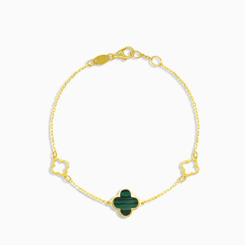 Gold bracelet with green clover leaf