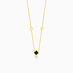 Gold necklace with black clover leaf