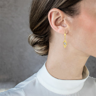 Dangling spiral gold earrings with a ball