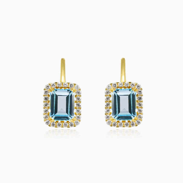 Pendientes de oro con halo y topacio azul en corte esmeralda