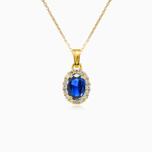 Oval blue quartz in gold pendant
