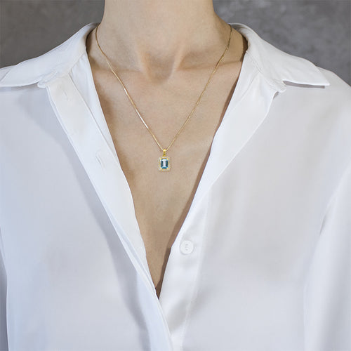 Halo emerald-cut blue topaz gold pendant