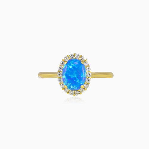 Oval halo blue opal gold ring